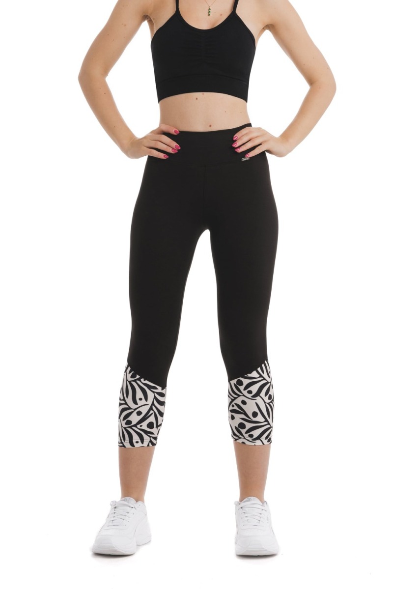 Črne capri pajkice Zampilo s črnim abstraktnim vzorcem listov in pik na belem ozadju na dnu hlačnic